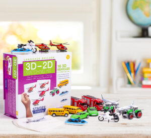 Toy vehicles with matching flashcards and colorful box sitting on a home table